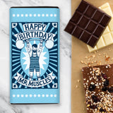 Chocolate Bar Packaging Design which is a blue illustration of a man lifting weights and the wording says 'Happy Birthday Mr Muscles' 