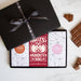 Three chocolate bars in a sleek black gift box tied by a Quirky-branded ribbon 