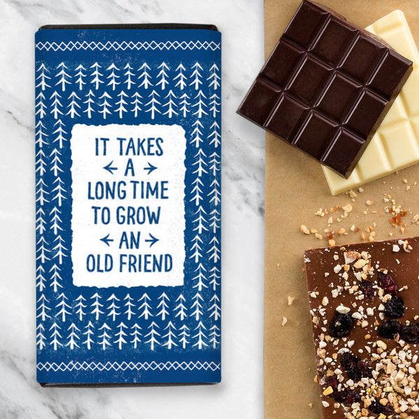 Chocolate Bar with Blue Wrapper Design and Illustrated Trees with the wording 'It Takes A Long Time To Grow An Old Friend'
