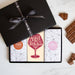 Three chocolate bars in a sleek black gift box tied by a Quirky-branded ribbon 